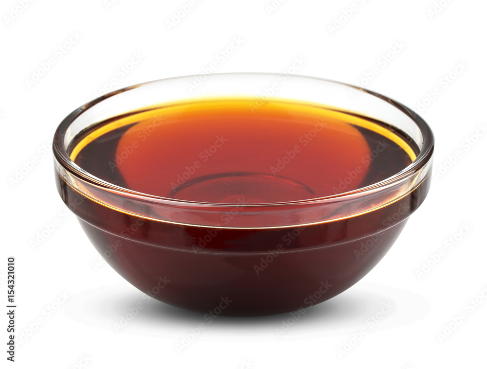 Golden syrup isolated on white background, honey in bowl