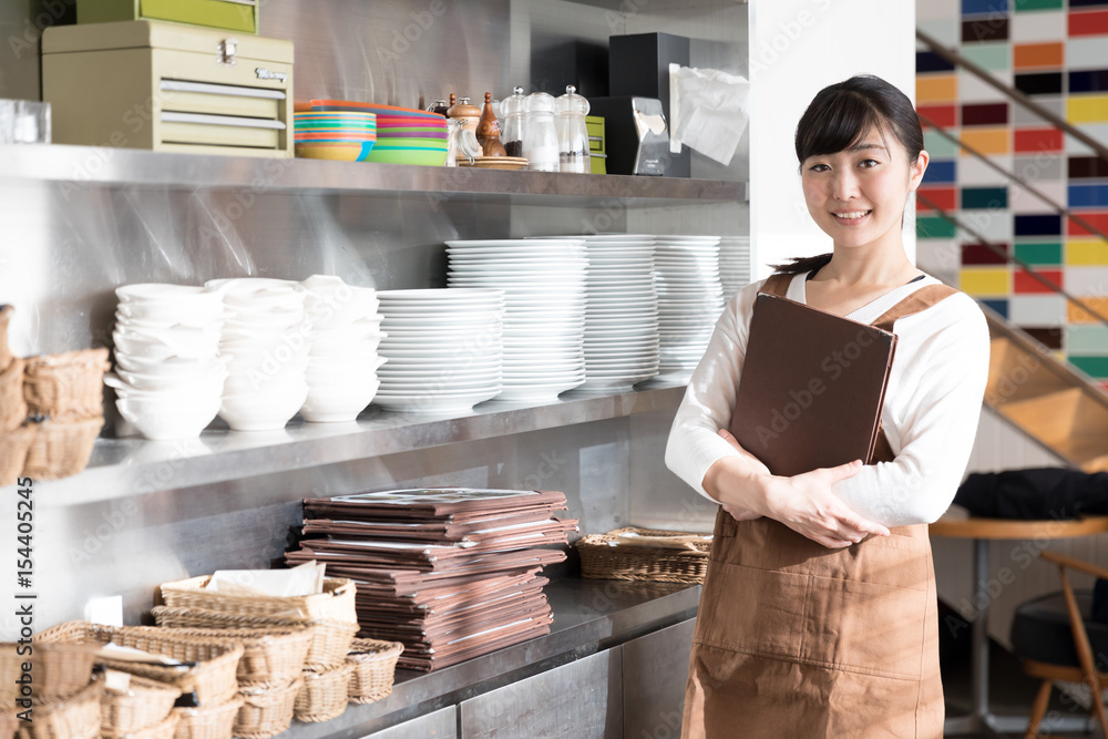 portrait of young asian waitress in cafe