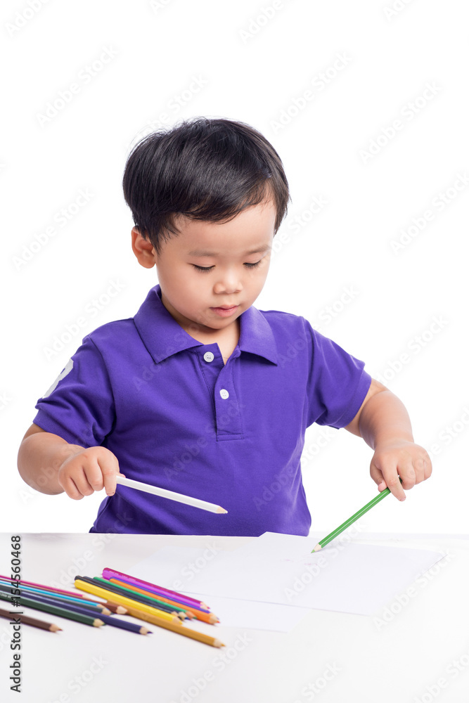 Portrait of cheerful boy drawing with colorful pencils