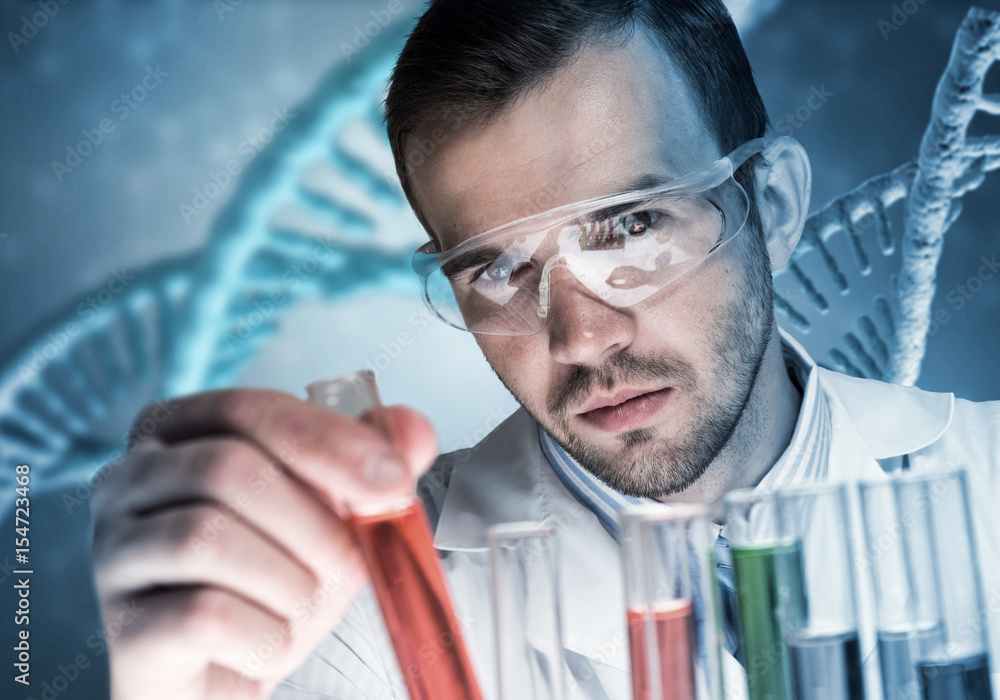 Young scientist mixing reagents in glass flask in clinical laboratory