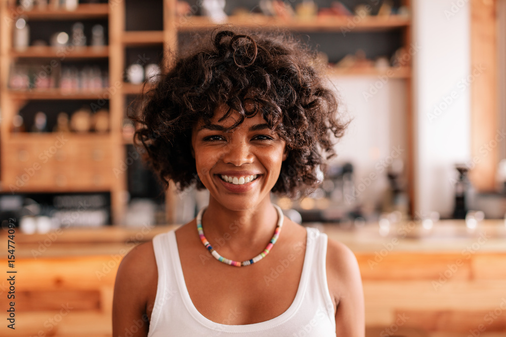 Smiling young african female in a coffee shop