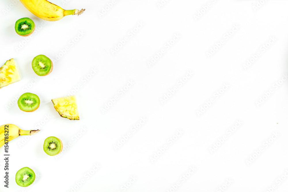 kiwi, pineapple, banana for healthy fruit dessert on white table background top view mock up