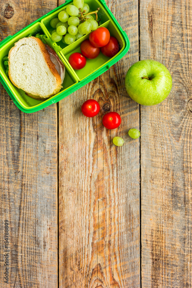 school lunch set with apple and vegetables in lunchbox background top view mock up