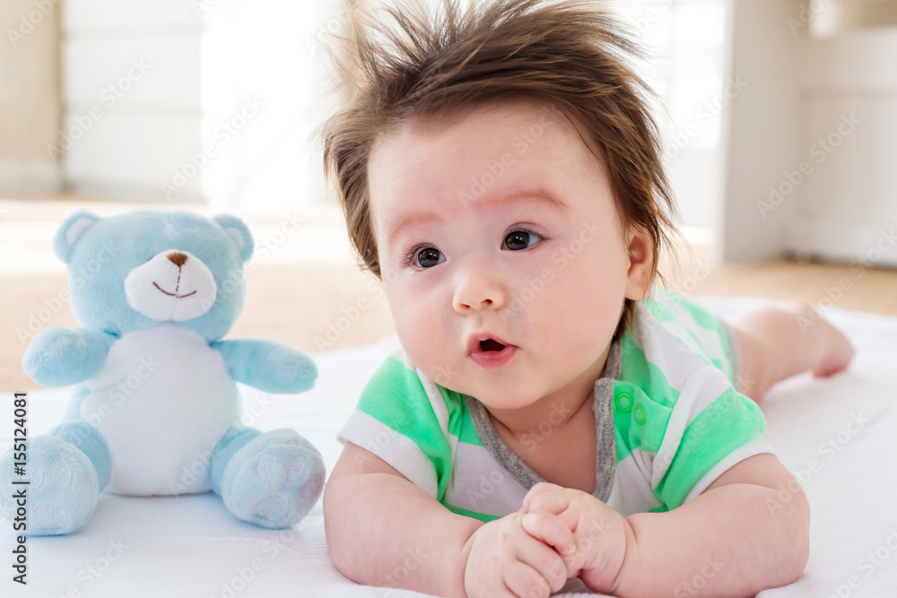 Happy baby boy with teddy bear