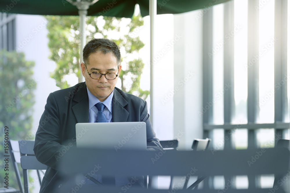 Executive businessman  working with laptop computer at outdoor cafe