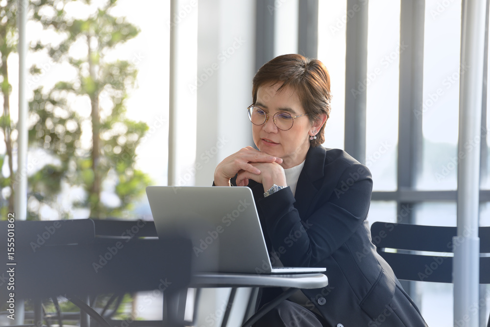 Executive businesswoman  working with laptop computer at outdoor cafe