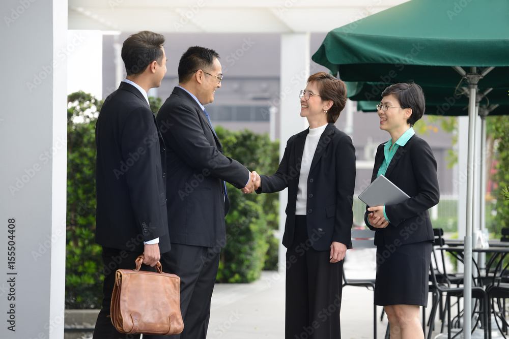 Business people shaking hands, finishing up a meeting