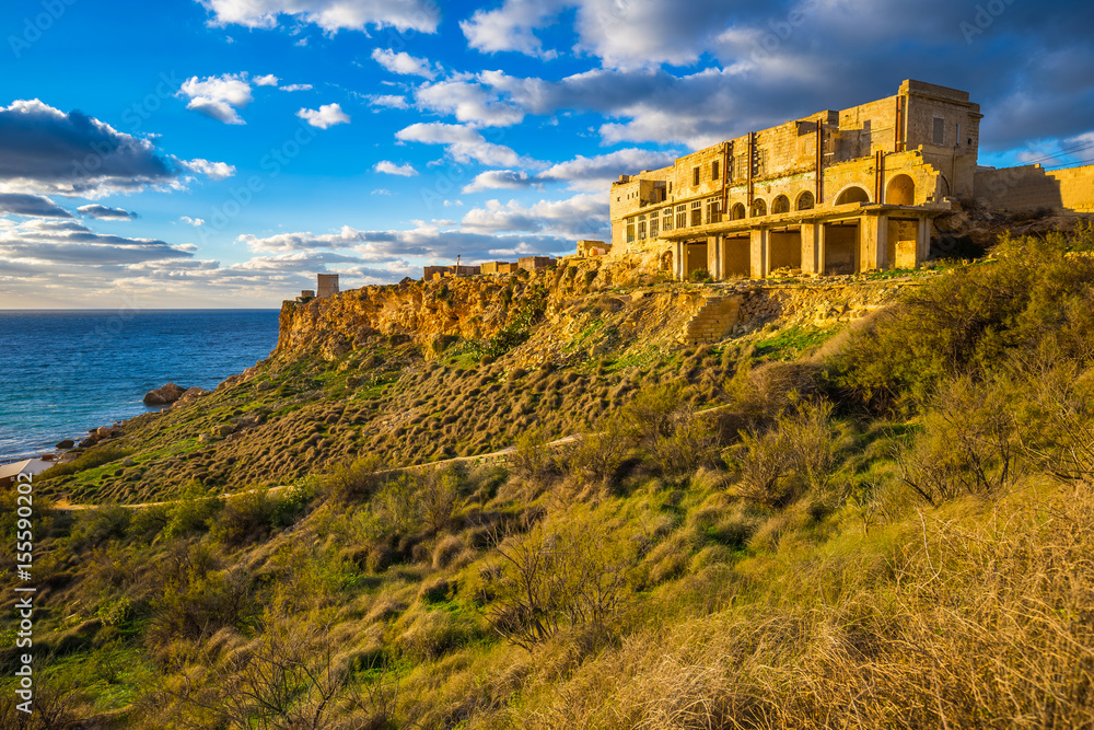 Ghajn Tuffeha, Malta - Golden hour at Ghajn Tuffieha beach on a lovely summer day with beautiful sky