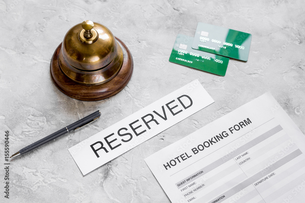 reservation form on hotel reception stone desk background