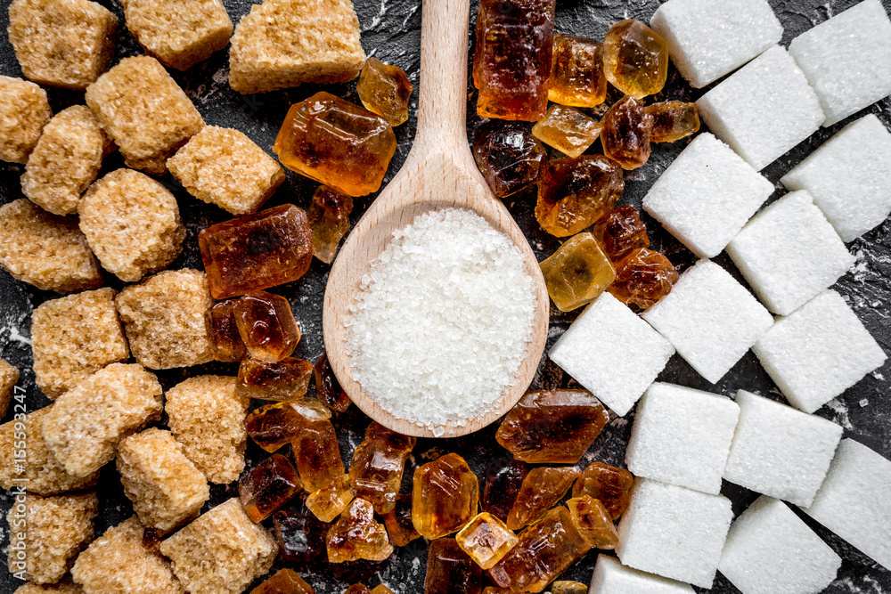 cooking sweets set with sugar in spoons on kitchen table background top view pattern