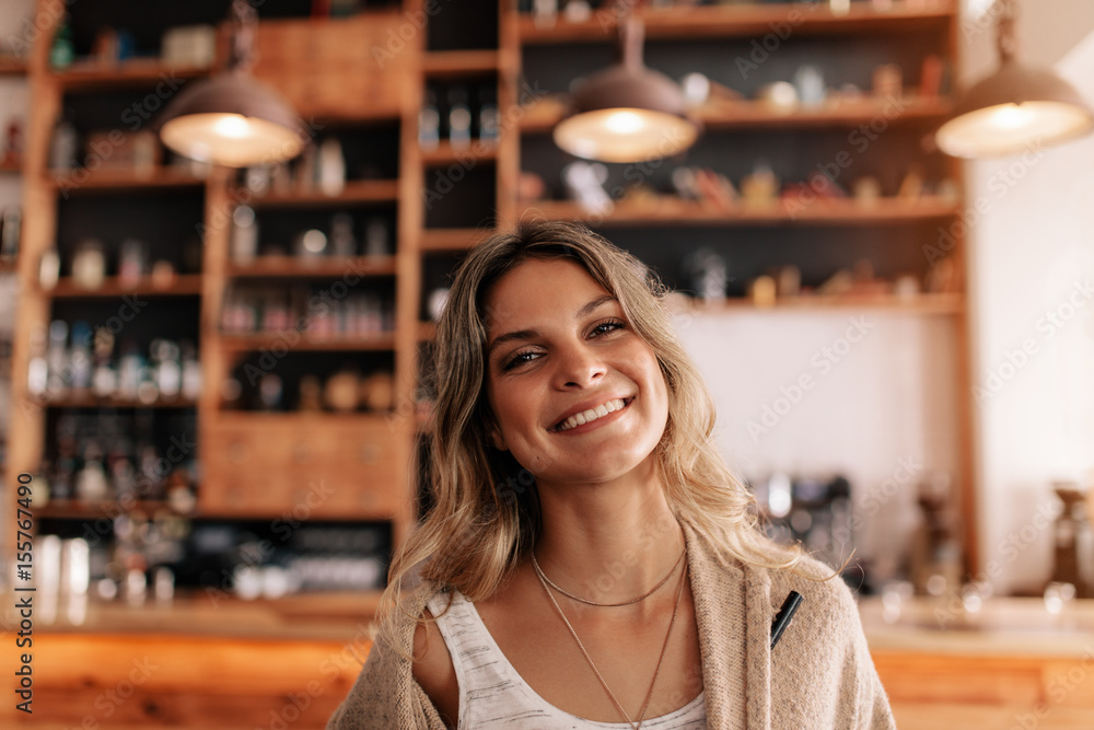 Portrait of beautiful young woman in a cafe