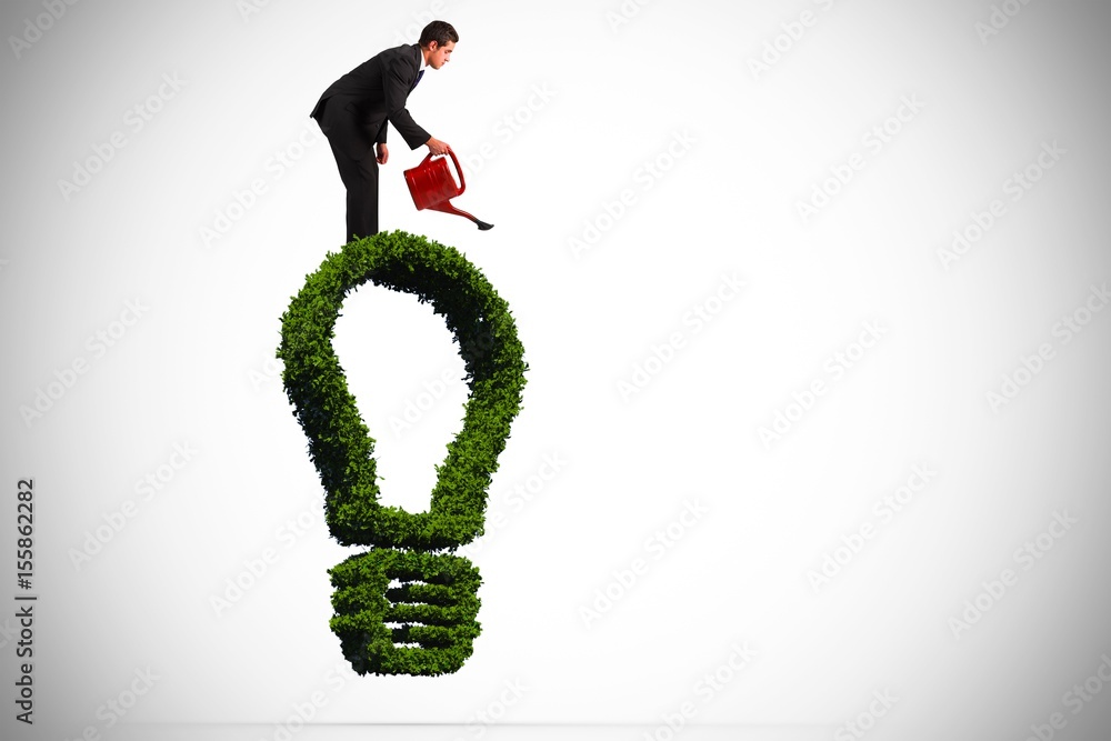 Composite image of businessman watering with red can