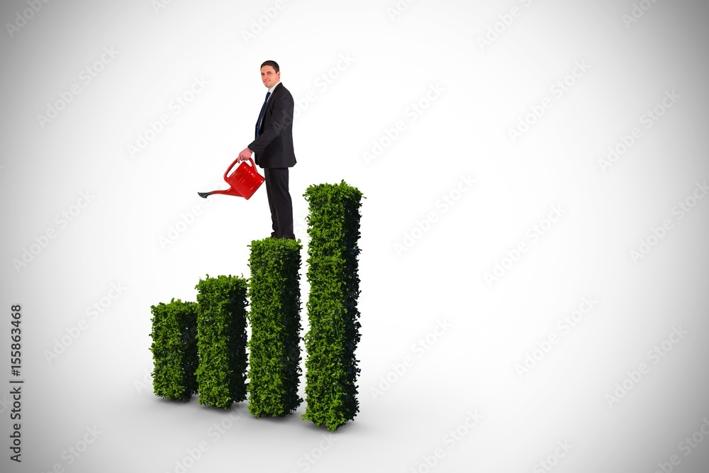 Composite image of businessman holding red watering can