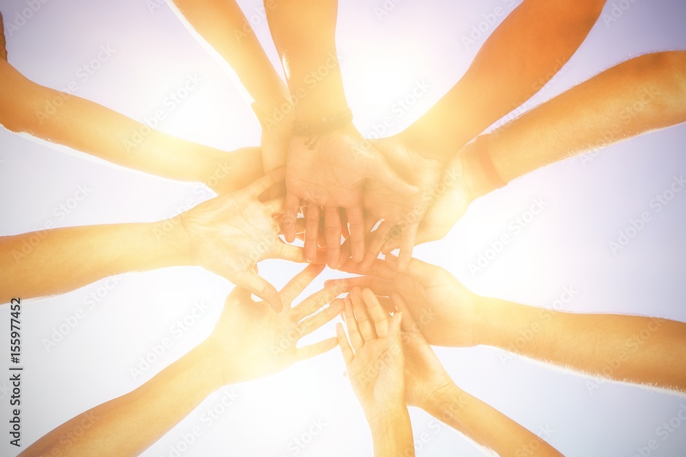 Directly below shot of friends stacking hands