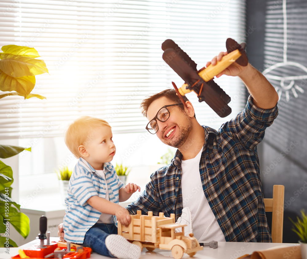 father and son toddler gather craft a car out of wood and play