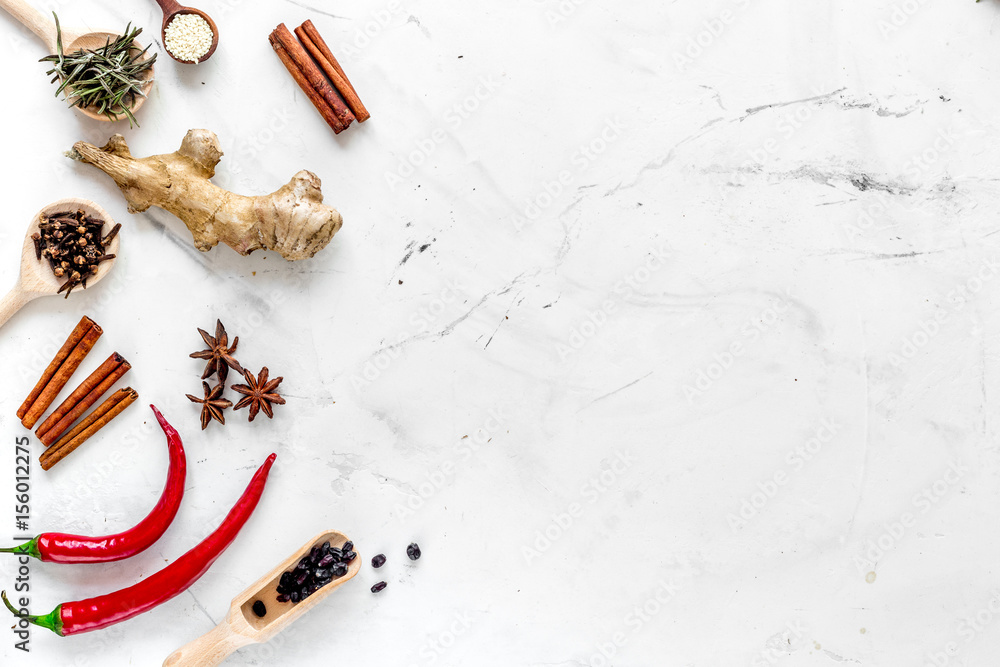 Spices, chili and cinnamon on white kitchen table background top view mock up