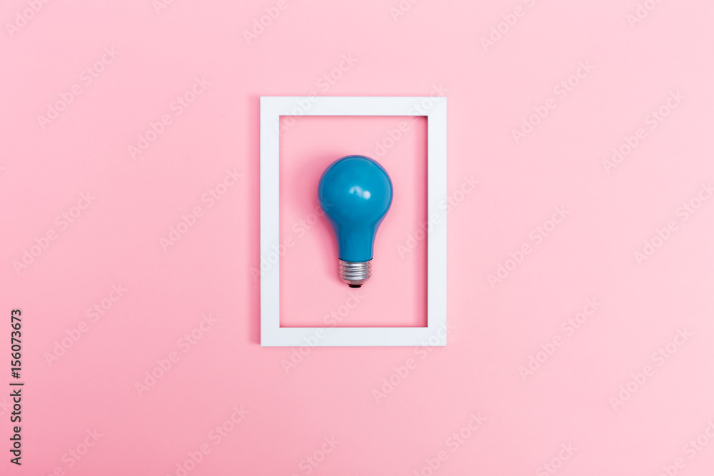 Colored lightbulb on a pink background