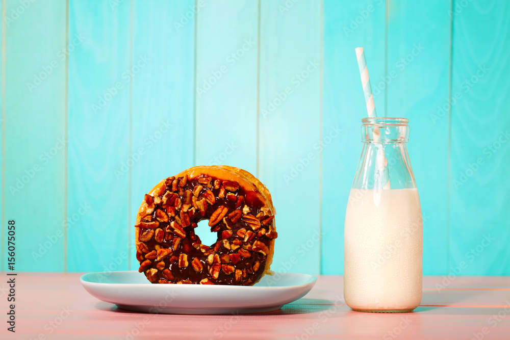 Donut with milk on a pastel background