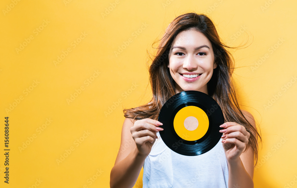 Happy young woman holding a record