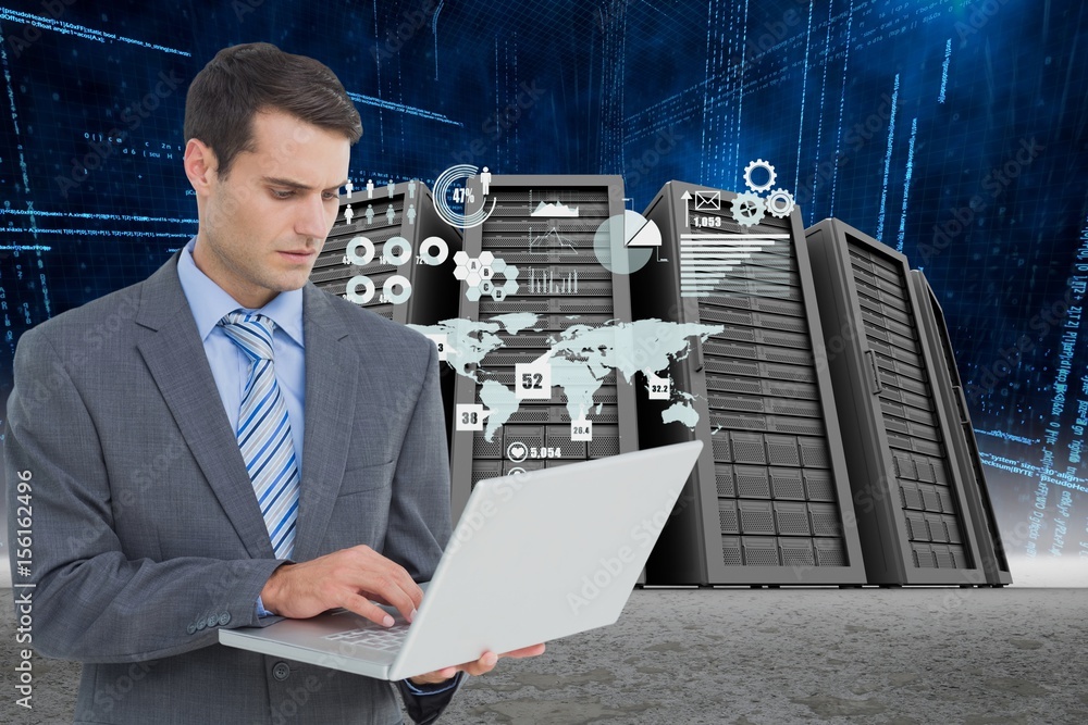 Businessman holding a laptop in a data center