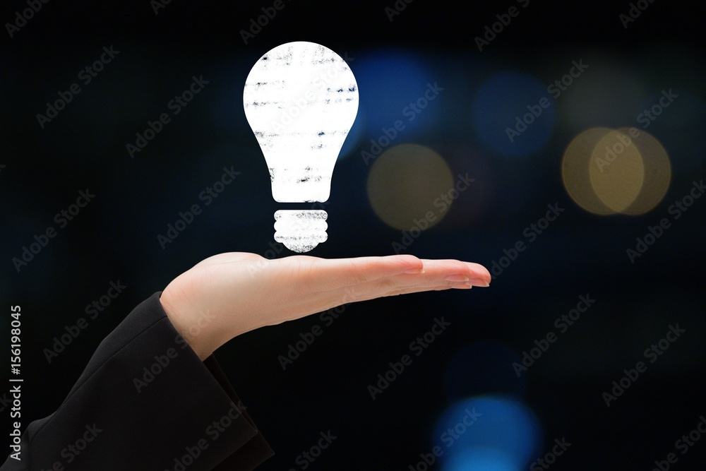 bulb on hands against black background 