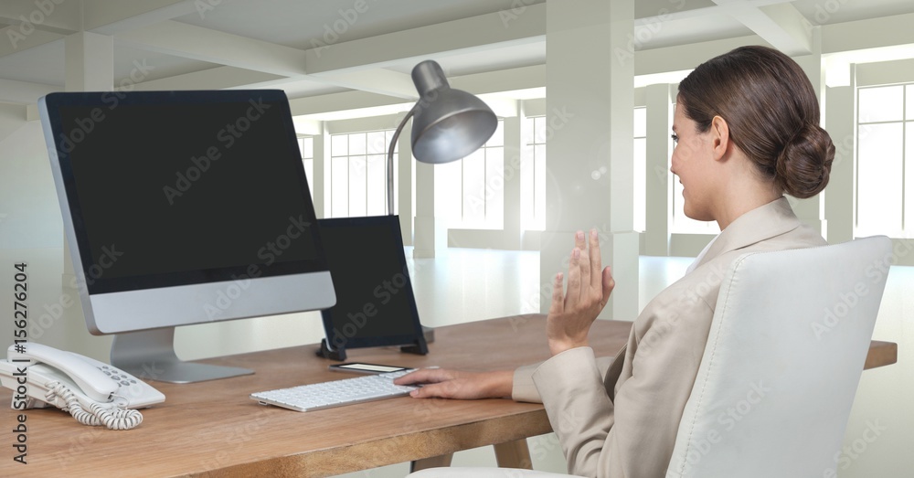 Businesswoman on computer at desk in office