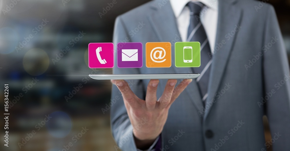 Businessman holding tablet with apps in night city