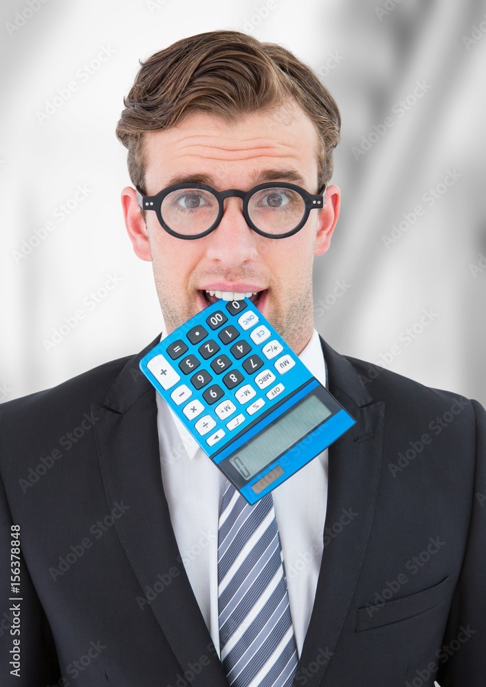 Man with calculator in mouth against blurry grey background