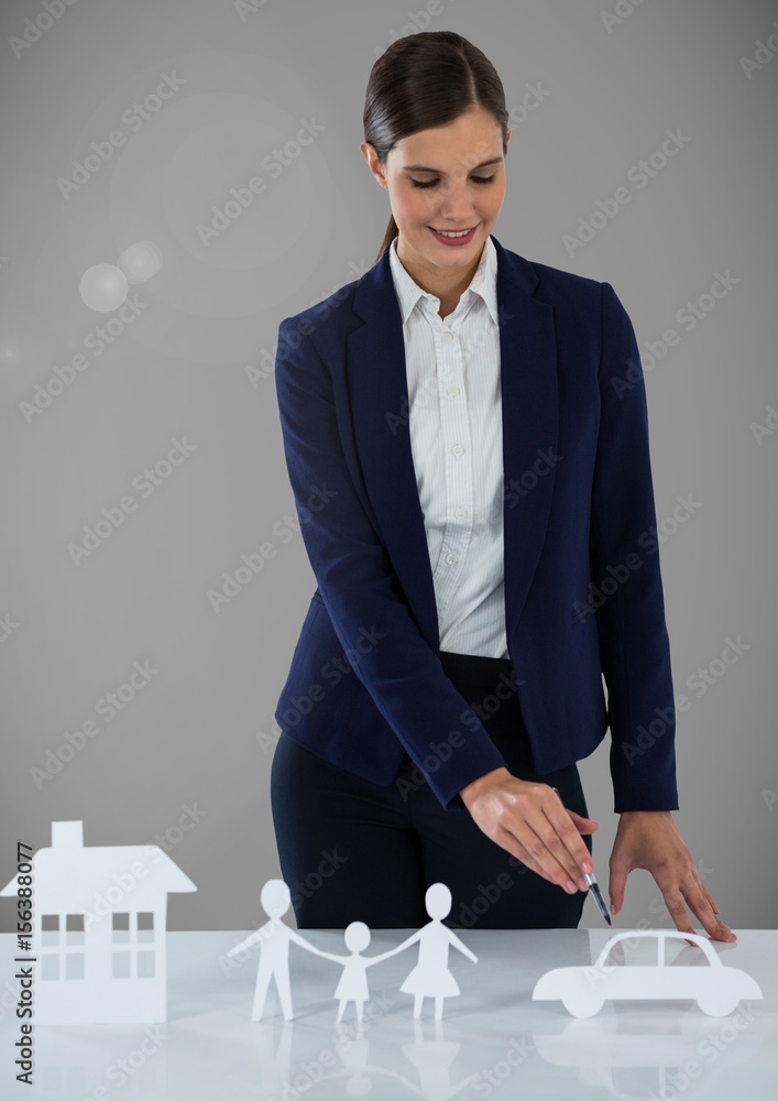 Woman with cut outs of  house family and car insurance