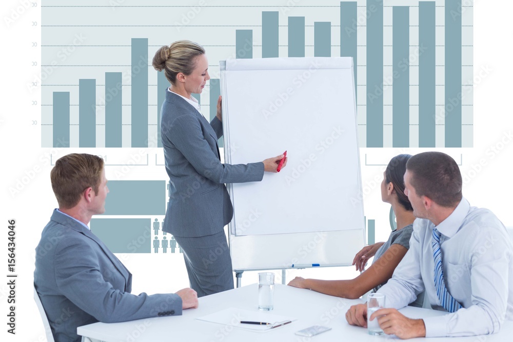 Businesswoman writing in a chart during a business meeting