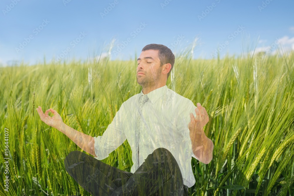 Man doing yoga in field of green sproutings