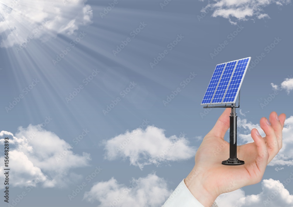 Digital image of hand holding solar panel on sky