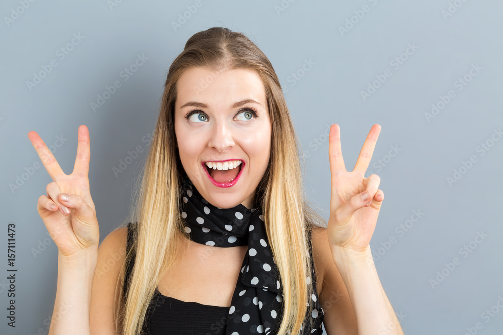 Young woman giving the peace sign