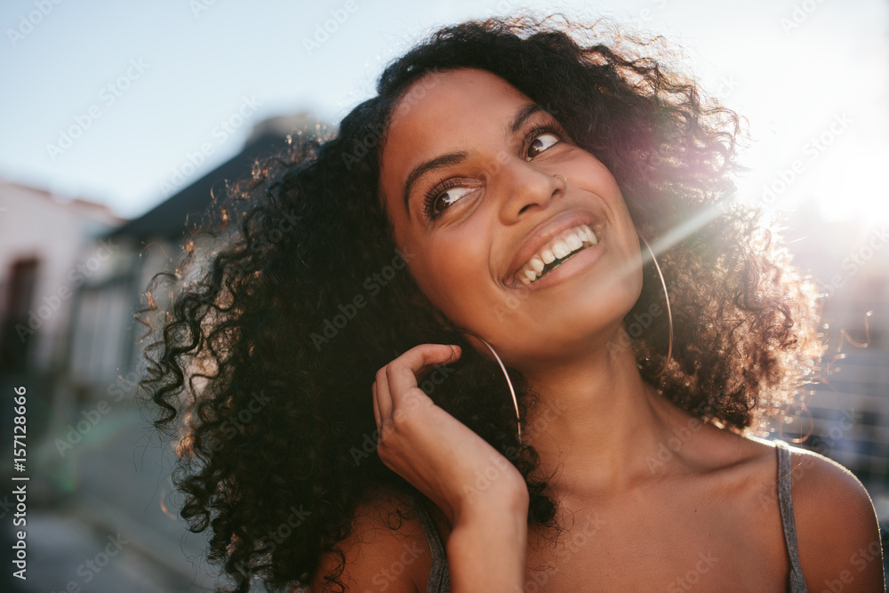 Afro american standing outdoors and smiling