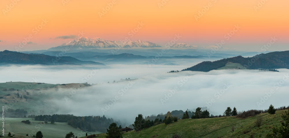 Beautiful spring panorama over misty Spisz highland to snowy Tatra mountains in the morning, Poland