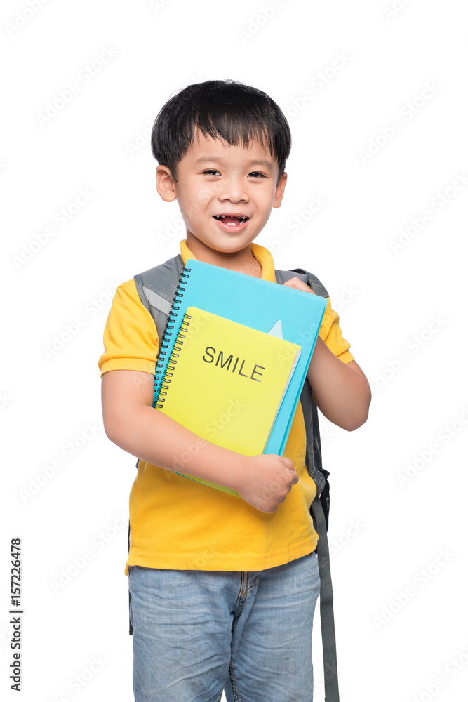 Portrait of cute smiling boy with backpack and colorful books, education and back to school concept