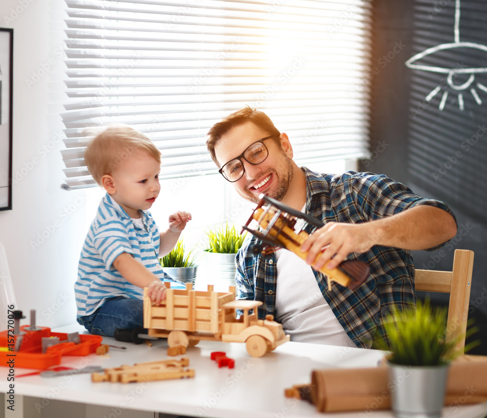 father and son toddler gather craft a car out of wood and play