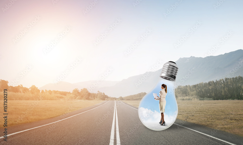 Businesswoman inside light bulb