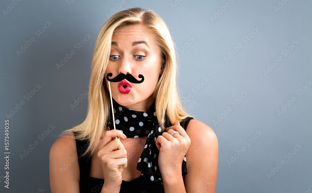 Young woman holding paper party sticks