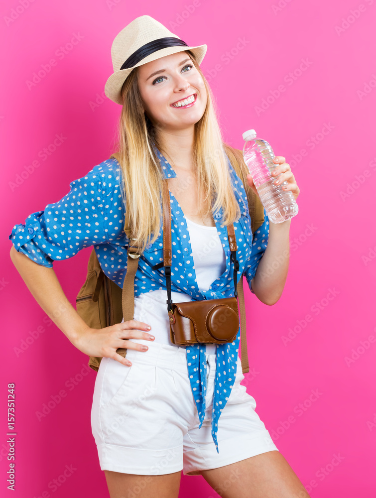 Happy Traveling woman with a water bottle