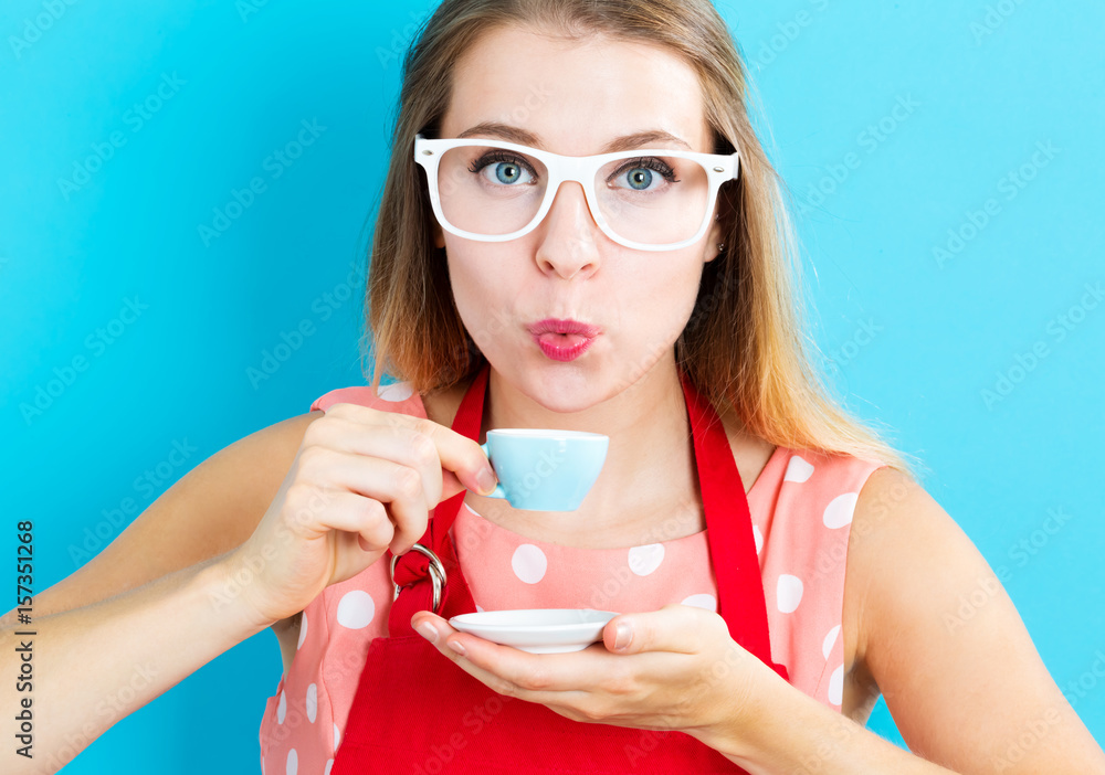 Happy young woman drinking coffee