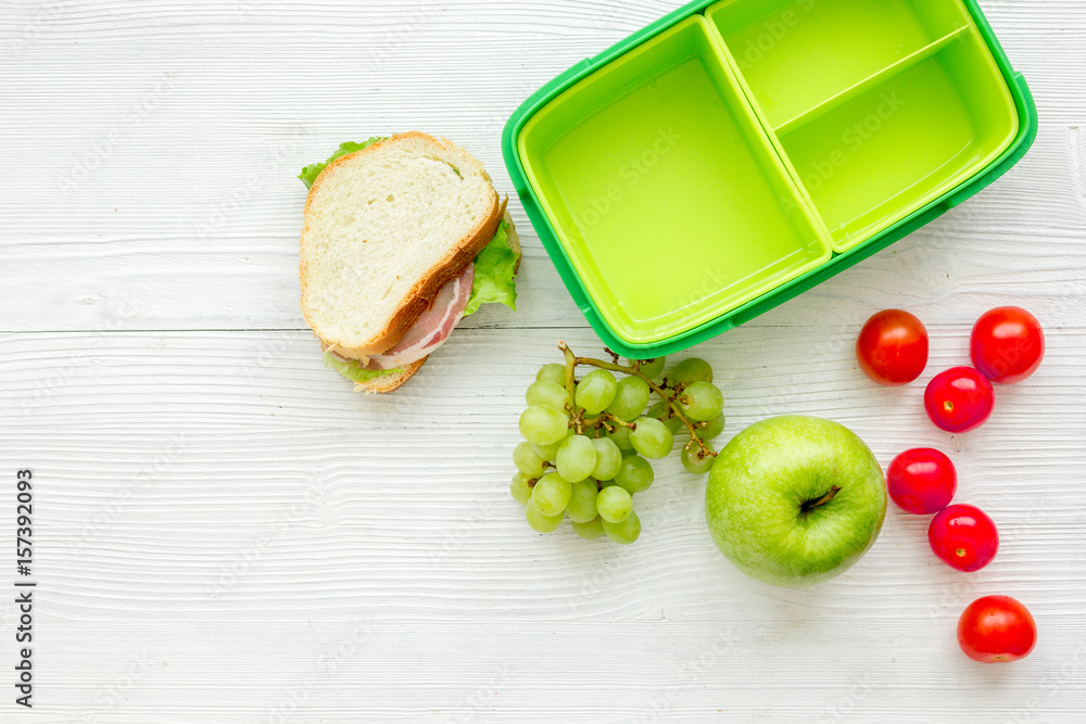 school lunch set with apple and vegetables in lunchbox background top view mock up