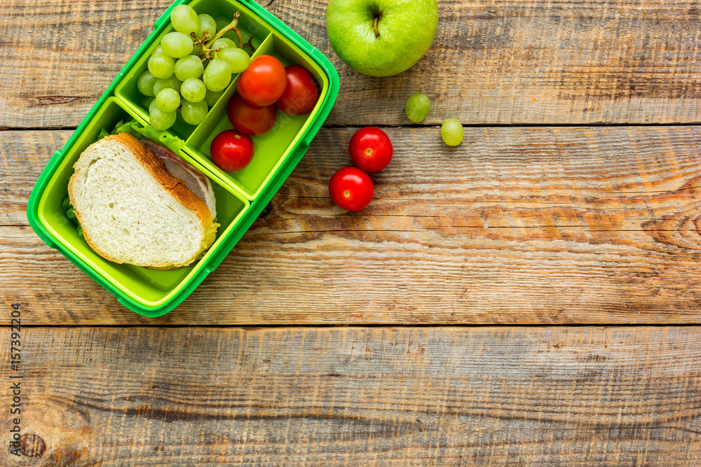 healthy food in lunchbox for dinner at school wooden table background top view mockup