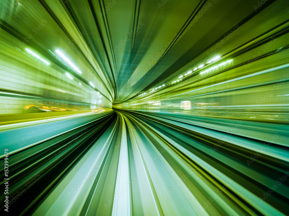 Motion blur train moving in city rail tunnel.