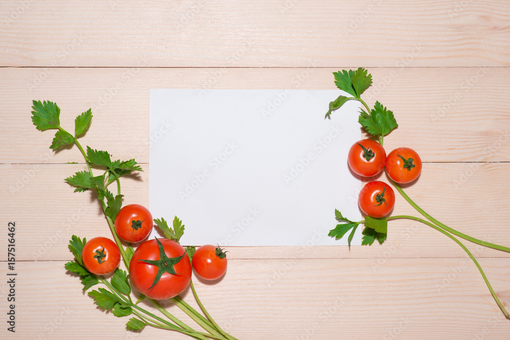 Open recipe book with fresh vegetables on wooden table.