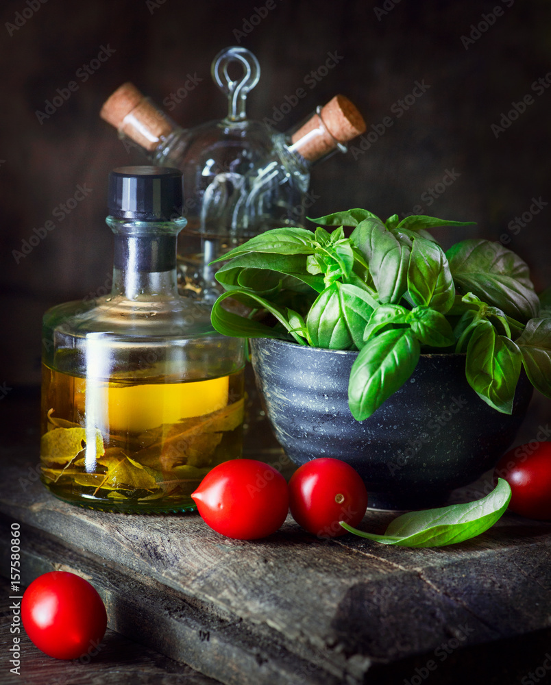 Food ingredients still life. Olive oil, cherry tomatoes, fresh basil leaves