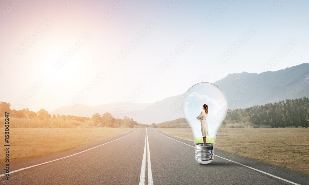 Businesswoman inside light bulb