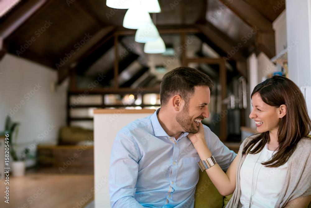 Portrait of smiling couple on the sofa looking at each other