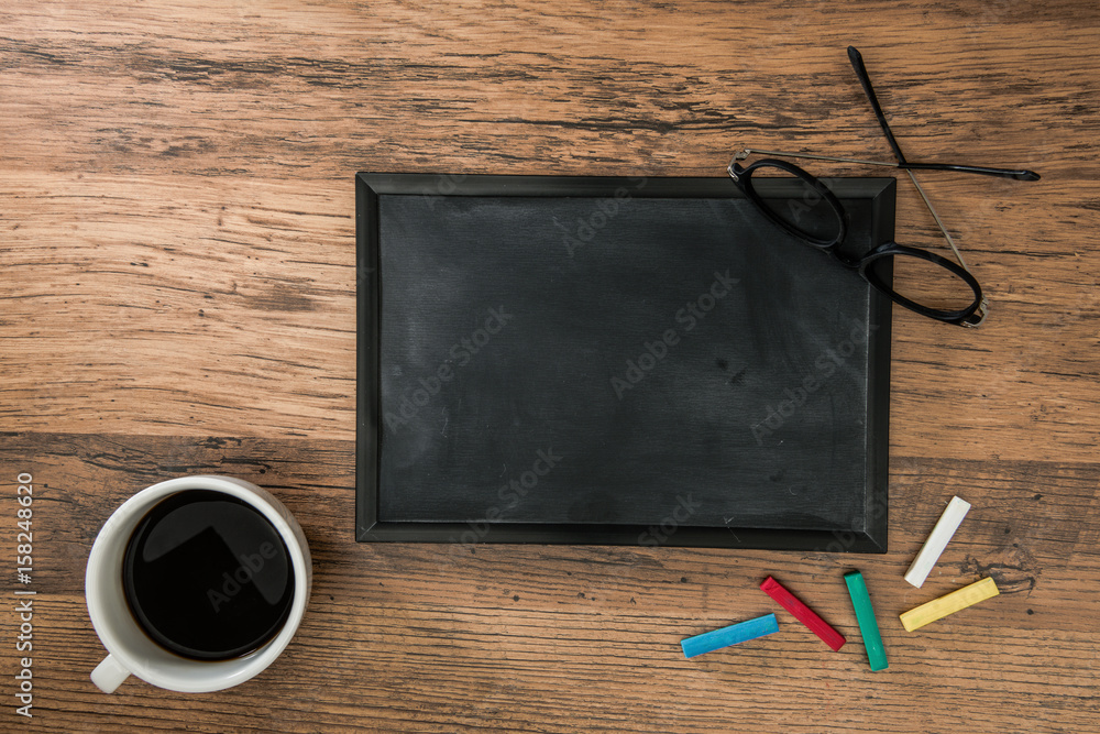 little blank blackboard on the wooden table