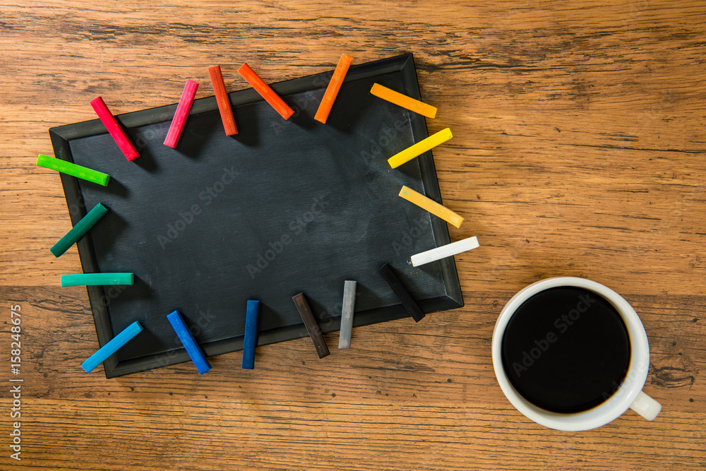 wooden floor with blank blackboard on the desk